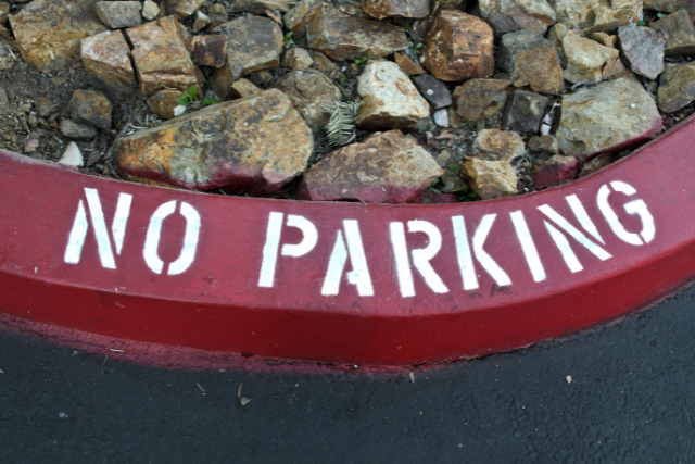 Curve pained red with sign "no parking'.