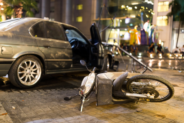 A collision between a car and a bicycle at night.