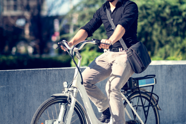 Man commuting to work on an electric bike in an urban area